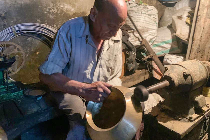 Kewal dotting a brass kadhai which is to pass from a mother to a daughter