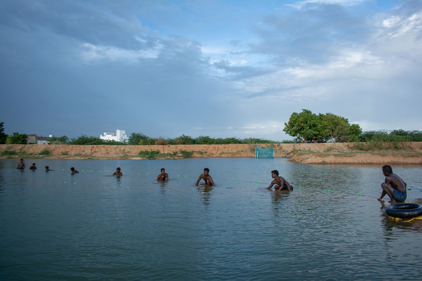 They cast their fishing nets and get into the deeper end of the lake