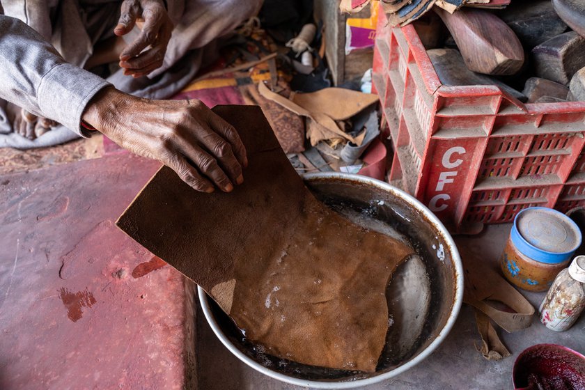 Left: He soaks the tanned buffalo hide before it can be used.