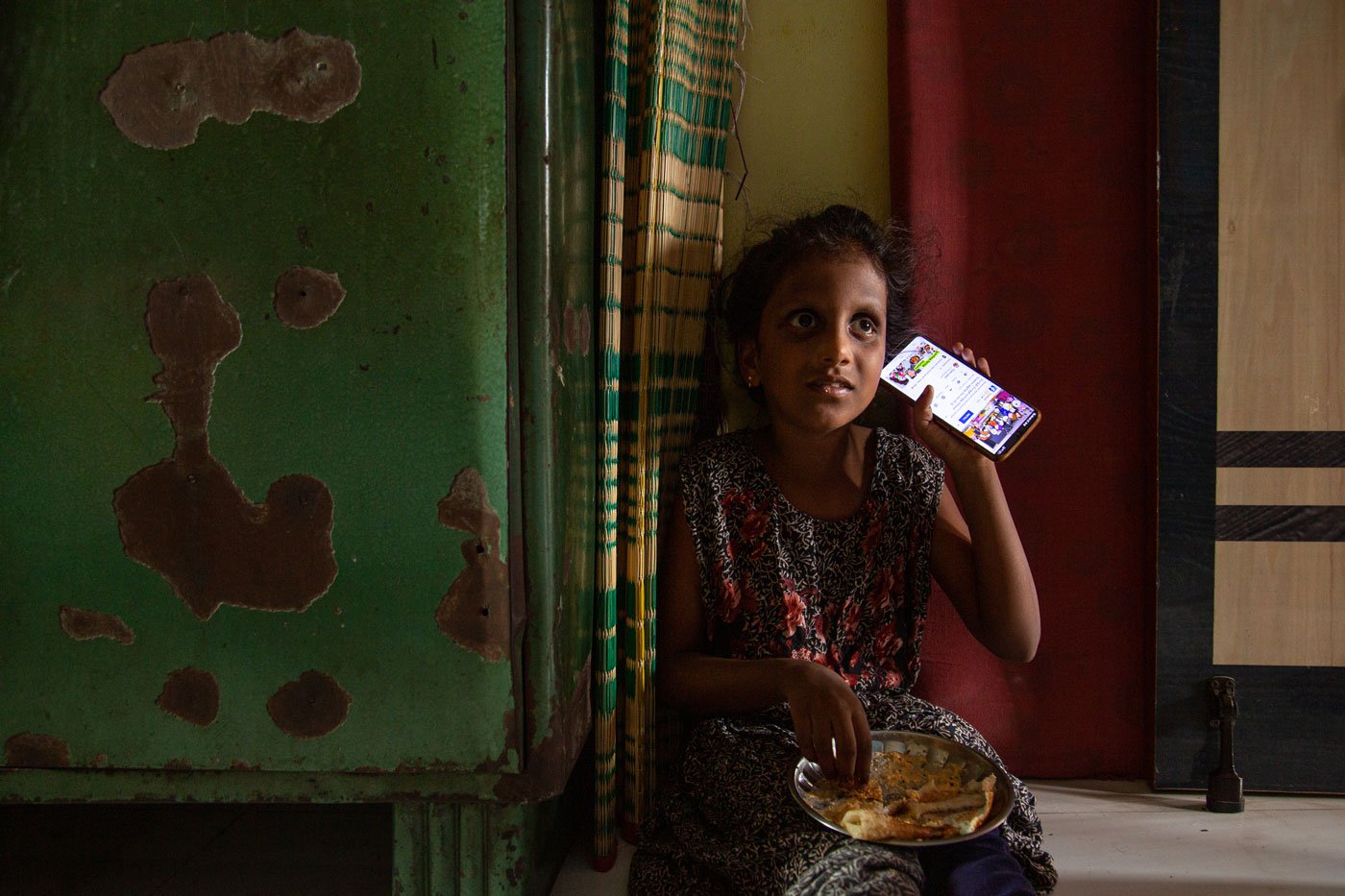 Lebana listening to Tamil songs on Youtube on her mother's phone; she sometimes hums the tunes