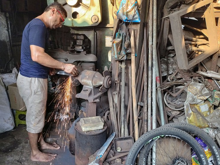 Rajesh sharpens (left) and then files (right) the newly crafted tools before they are handed over to the customer