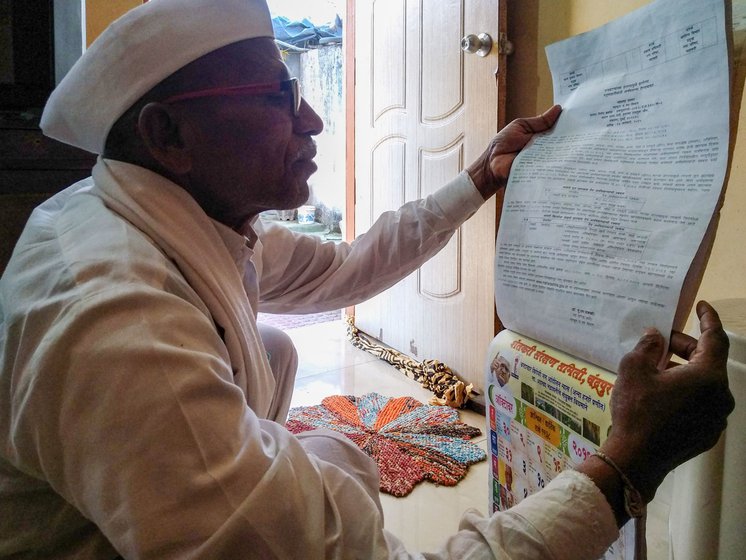 He is showing calendars that he prints to raise awareness and educate farmers about the procedure to claim compensation