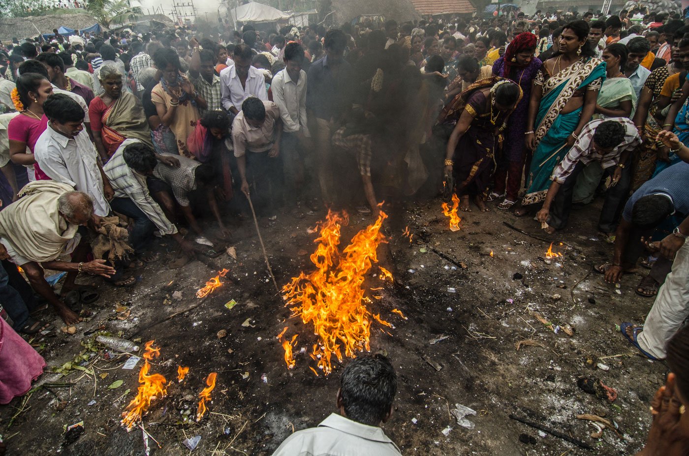 People from nearby villages, who have come for the festival, gather around