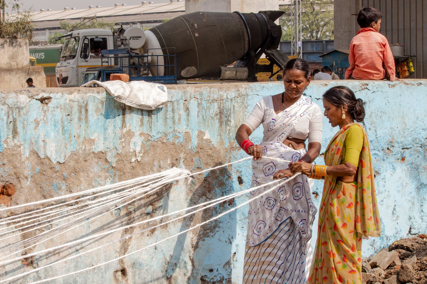 As their homes are too small to accommodate the work, the women work in the open with no protection from the sun