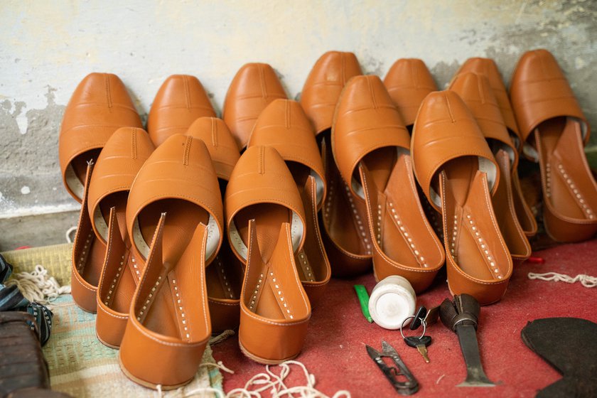 Young shoemakers like Raj Kumar (left) say that artificial leather is now more commonly used for making juttis . In Guru Ravidas Colony in Malout where he lives and works, tanneries have shut