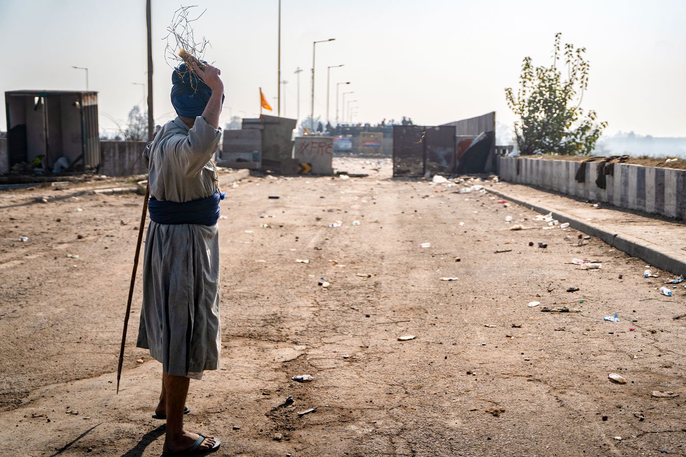 Farmer throws an exploded tear gas shell that the police fired back at them