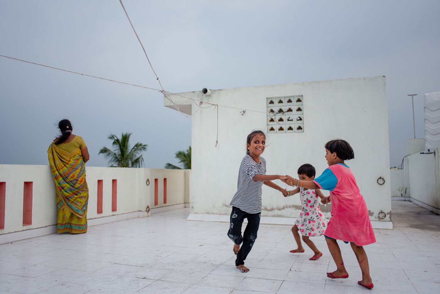 Lebana likes playing on the terrace of their building. She brings her friends to play along with her