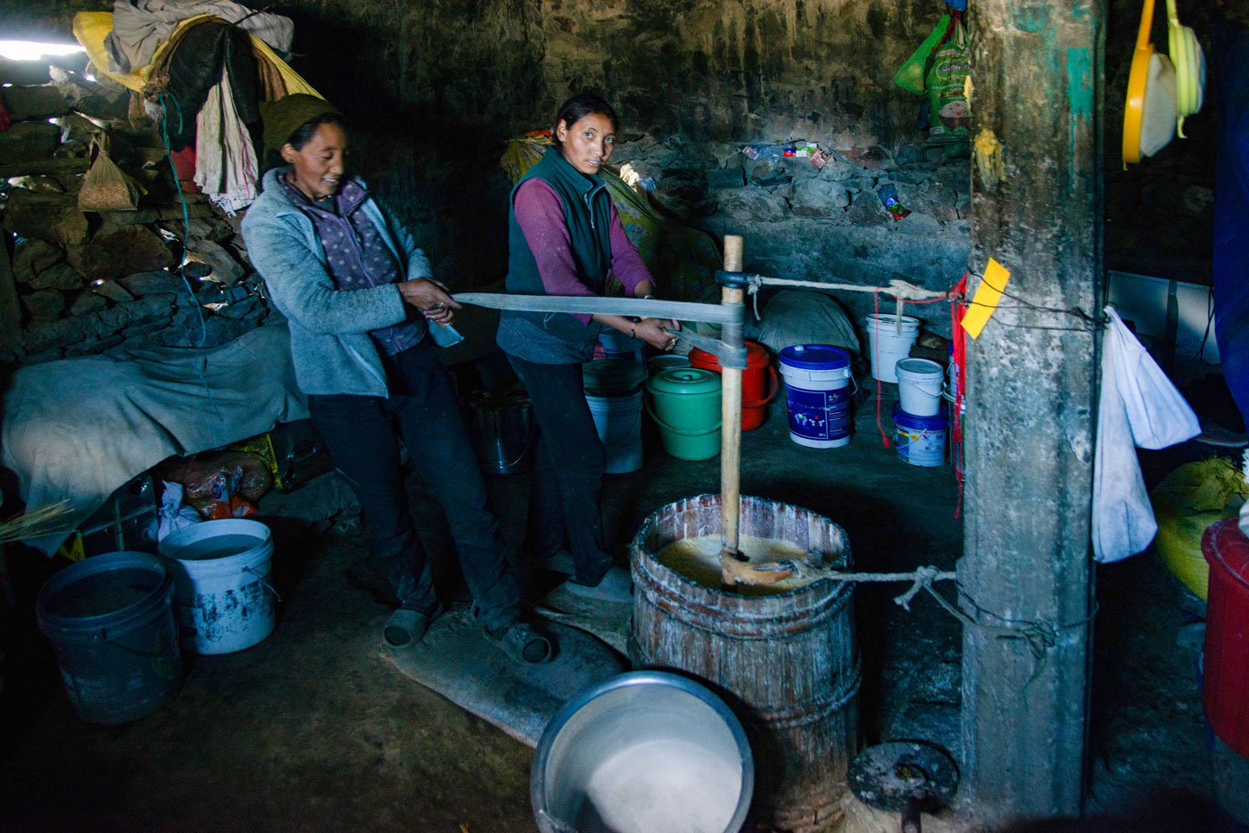 Women churn the milk to make ghee and churpi , which they then sell