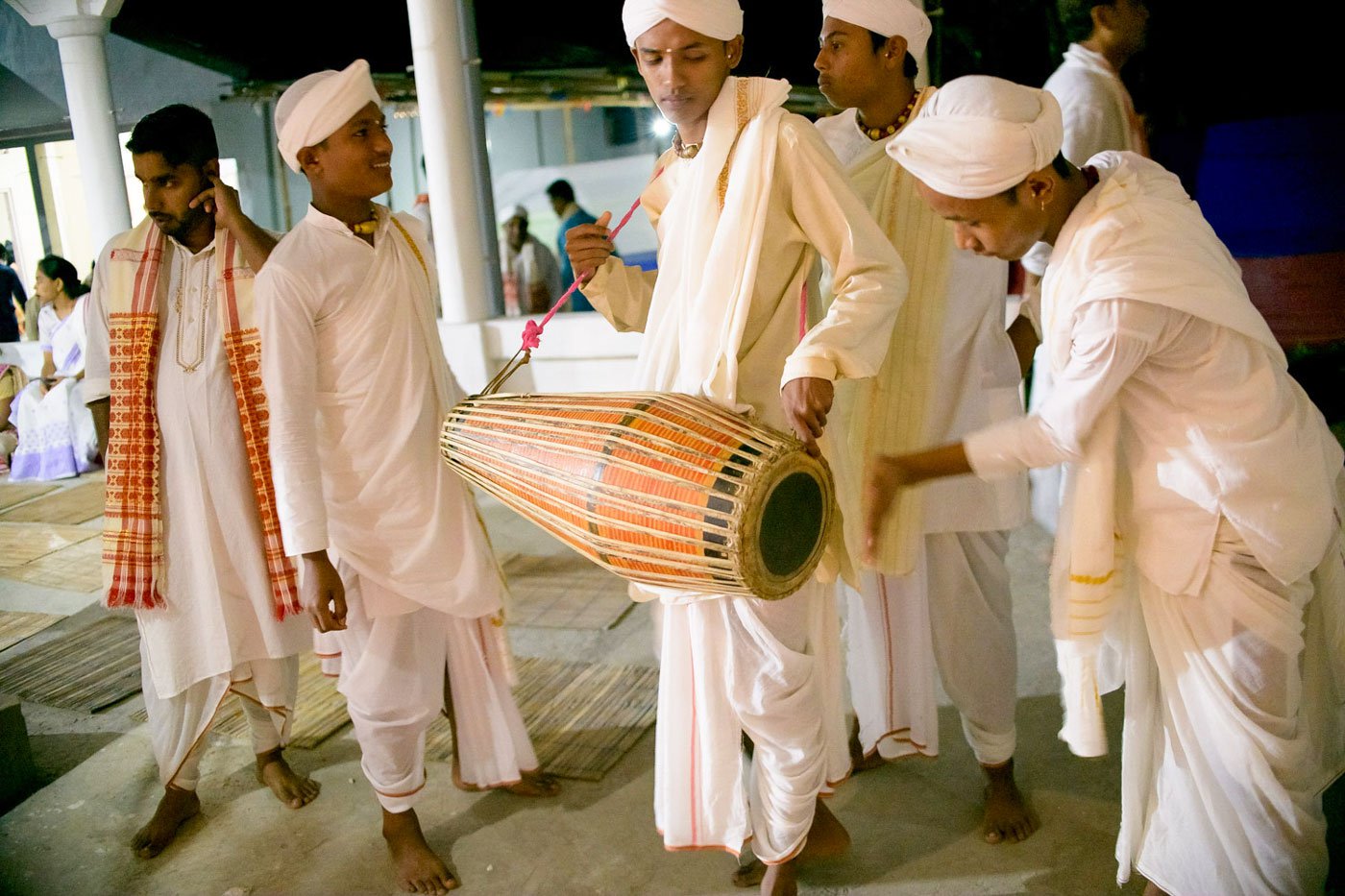 Nabajyoti Borah checks the khol held by Priyabrat as their fellow bayans Jyotishman (left) and Partha (right) look on