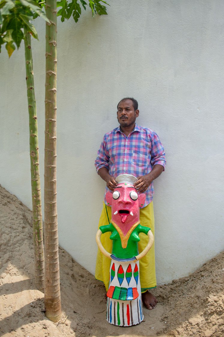 The finished idols with their maker (right)