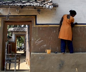 Santal women across the village work on the beautiful wall-art