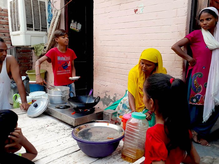 a boy with his family getting his pushcart ready 