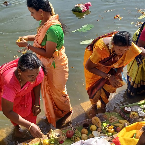 The crowd at Amma Mandapam (left), a ghat on the Cauvery on the occasion of Aadi Perukku where the river (right) is worshipped with flowers, fruits, coconut, incense and camphor.