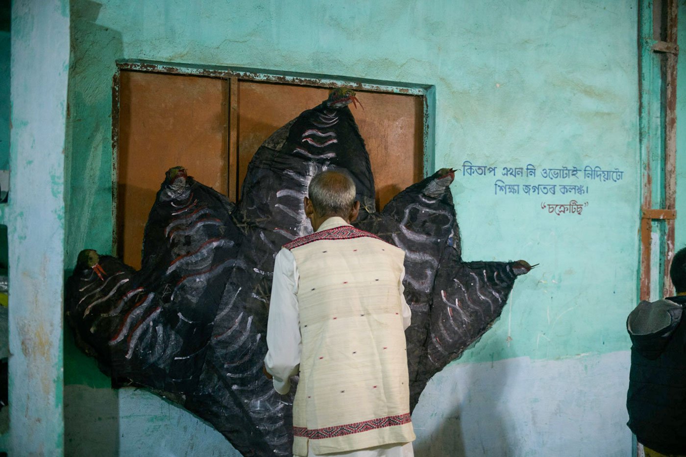 A Kaliyo Naag mask is painted at the Borun Chitadar Chuk village's venue for the festival