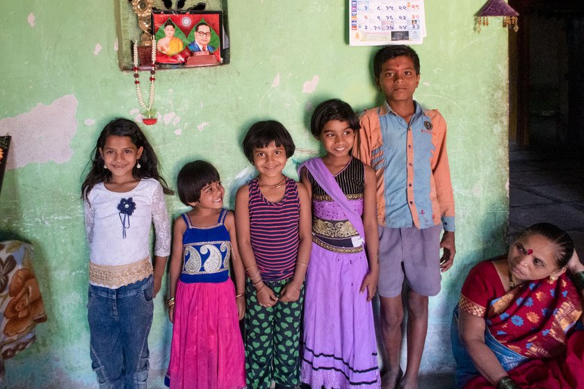 Left: A poster featuring Dr. Ambedkar in Kusumtai's home in Nandgaon. Right: Her granddaughters (second and fourth from left) with other children from the neighbourhood. 'We tell the children the life story of Babasaheb', says Kusumtai

