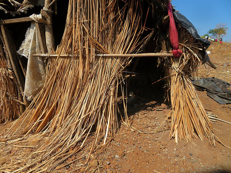 With no hospital bed available, Amol Barde isolated himself in this neighbour’s hut with a broken door, damaged roof and stone-strewn floor