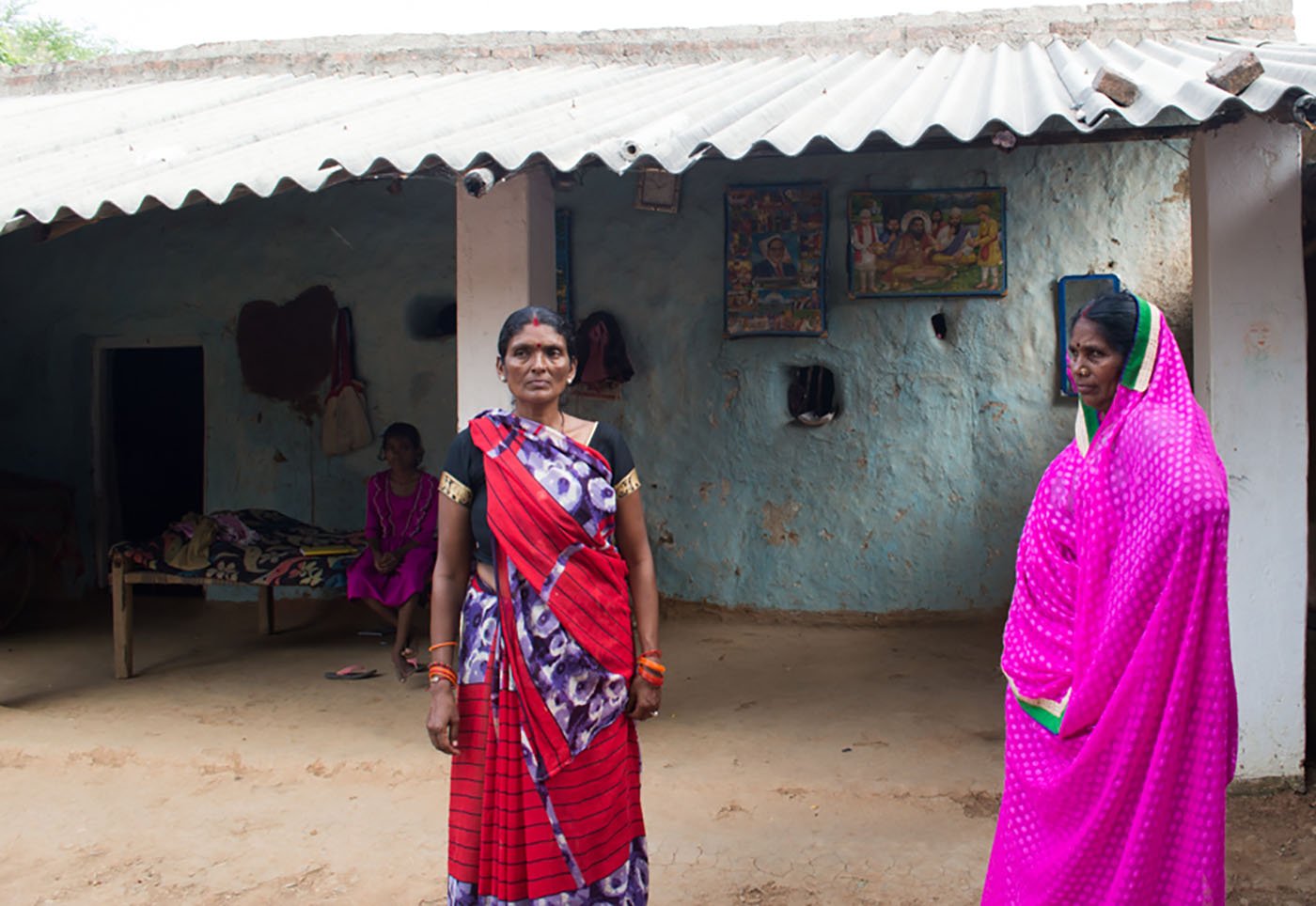 Women in open yard of home