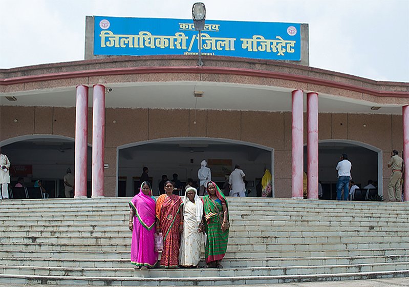 Women standing outside district magistrate's office 