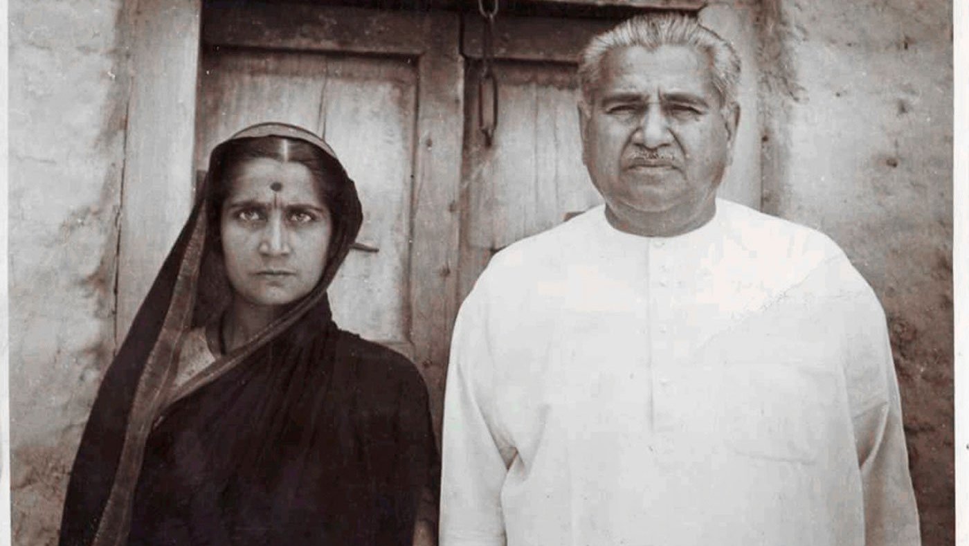 daughter and father standing outside home