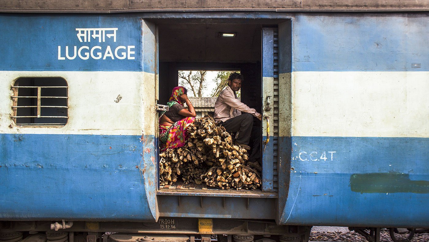 man and woman sitting in train