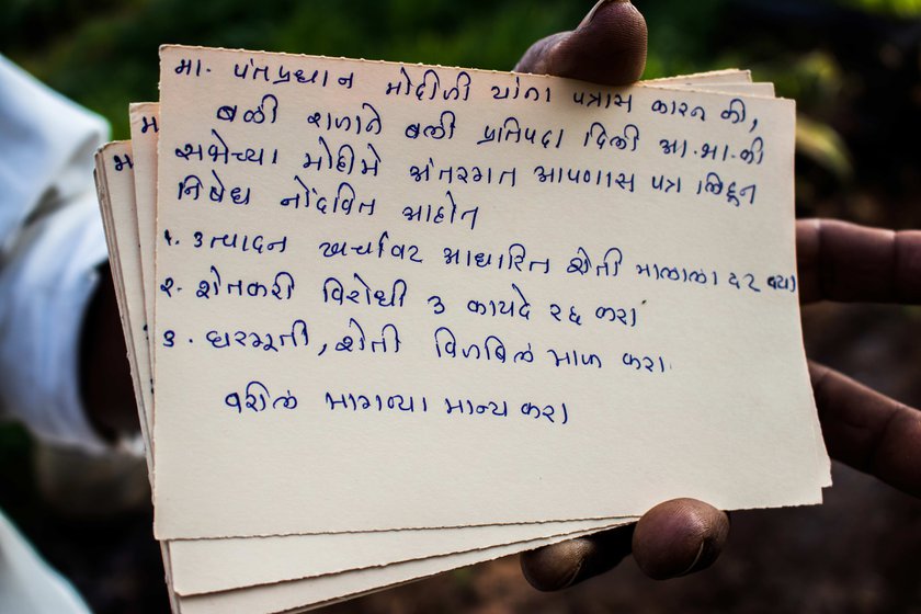 Left: Narayan always talks to the protesting farmers to know more about their struggles and takes notes in his diary. Right: Narayan has sent 250 postcards to Narendra Modi, asking him to repeal the three farm laws