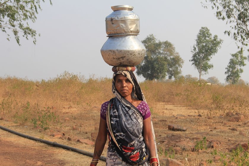 Woman with steel mutaka on her head