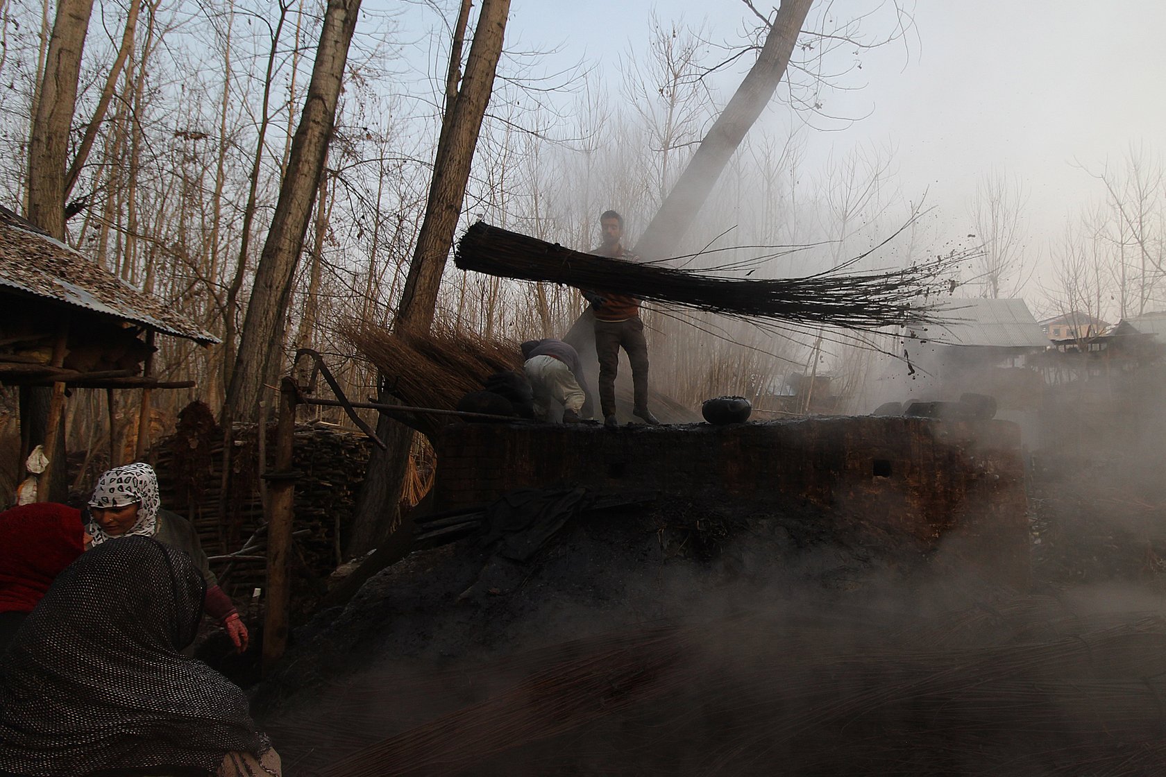 In Umerhere, Ashiq Ahmad, 22, and his father Gulzar Ahmad Dar, 54, at their workshop near their house, taking out a batch of wicker after boiling it overnight. “It is the first process after the wicker is harvested. Soaking the wicker makes it easier to peel off its rough skin,” Ashiq says