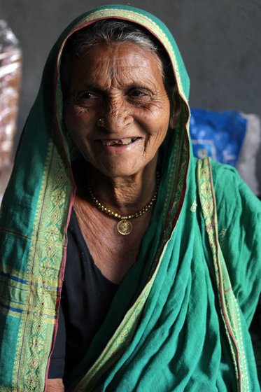 Radha Borhade in April 2017. Her daughter Kamal Salve (right) says Radhabai knows many songs devoted to Buddha