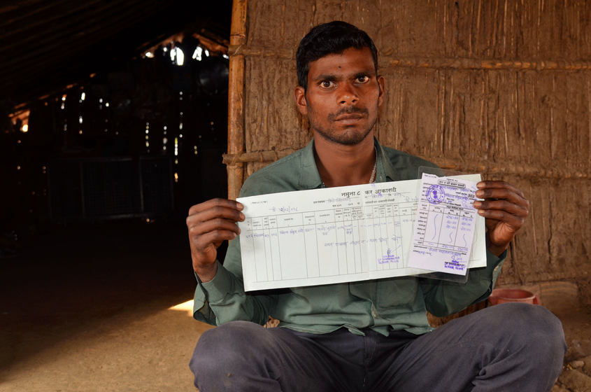 A man showing his house tax receipt 